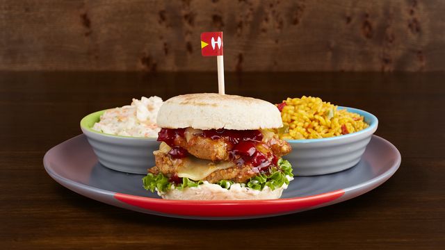 Sunset Burger on a plate with optional sides Spicy Rice and Mixed Leaf Salad