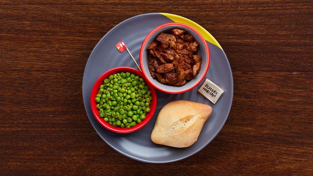 Chicken Livers and a Portuguese roll on a plate with an optional side of Macho Peas