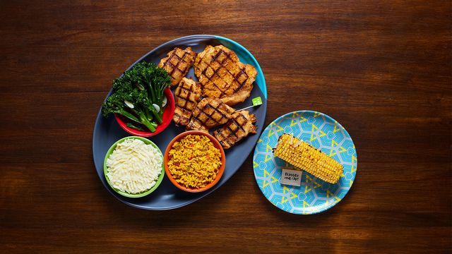 A Boneless Platter with optional sides Long Stem Broccoli, Creamy Mash, Spicy Rice and Corn on the Cob